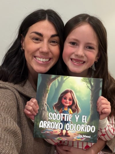 Smiling child holding a personalized storybook featuring their own name and photo