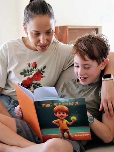 Happy child showing their printed personalized children's book gift