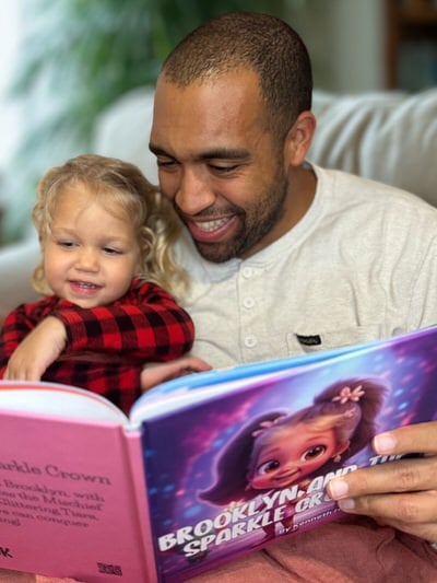 Excited child holding a custom photo personalized kids book